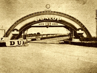 XK-120 Jaugar passes under Dunlop Bridge during practice session before the 1953 Le Mans